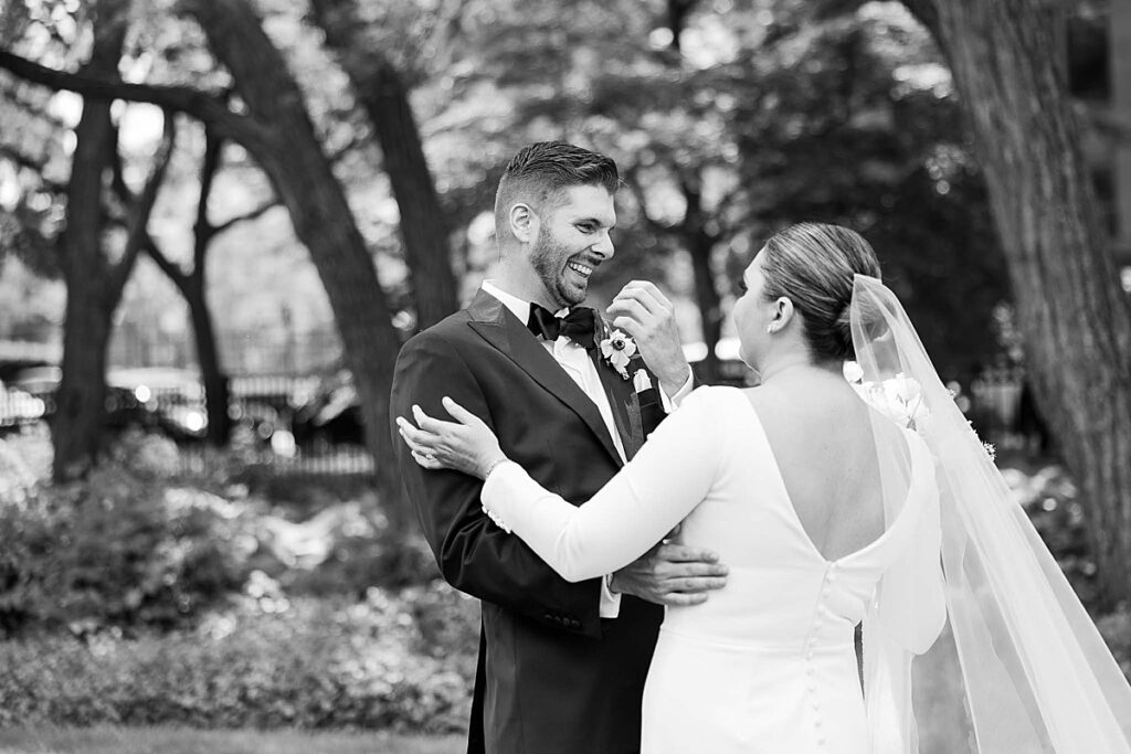 Black and white photo of groom smiling in Chicago, IL