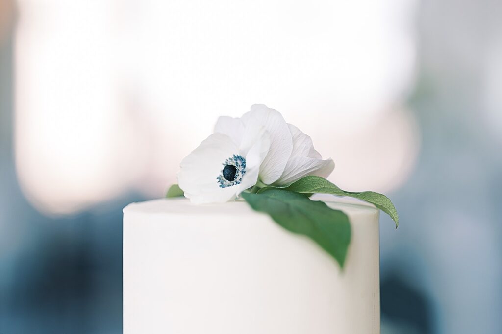 White wedding cake top with flower