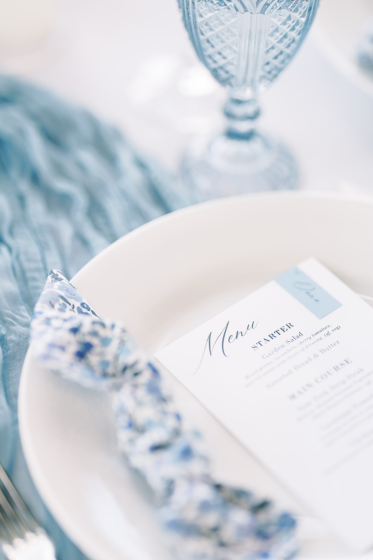 Blue and white place setting for wedding reception