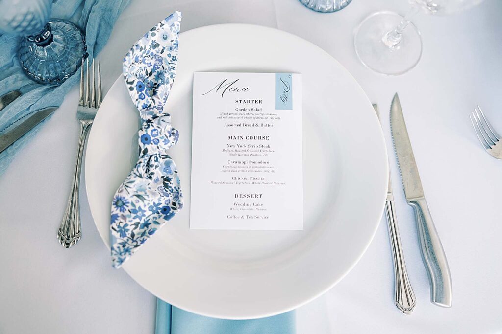 Blue and white place setting at wedding