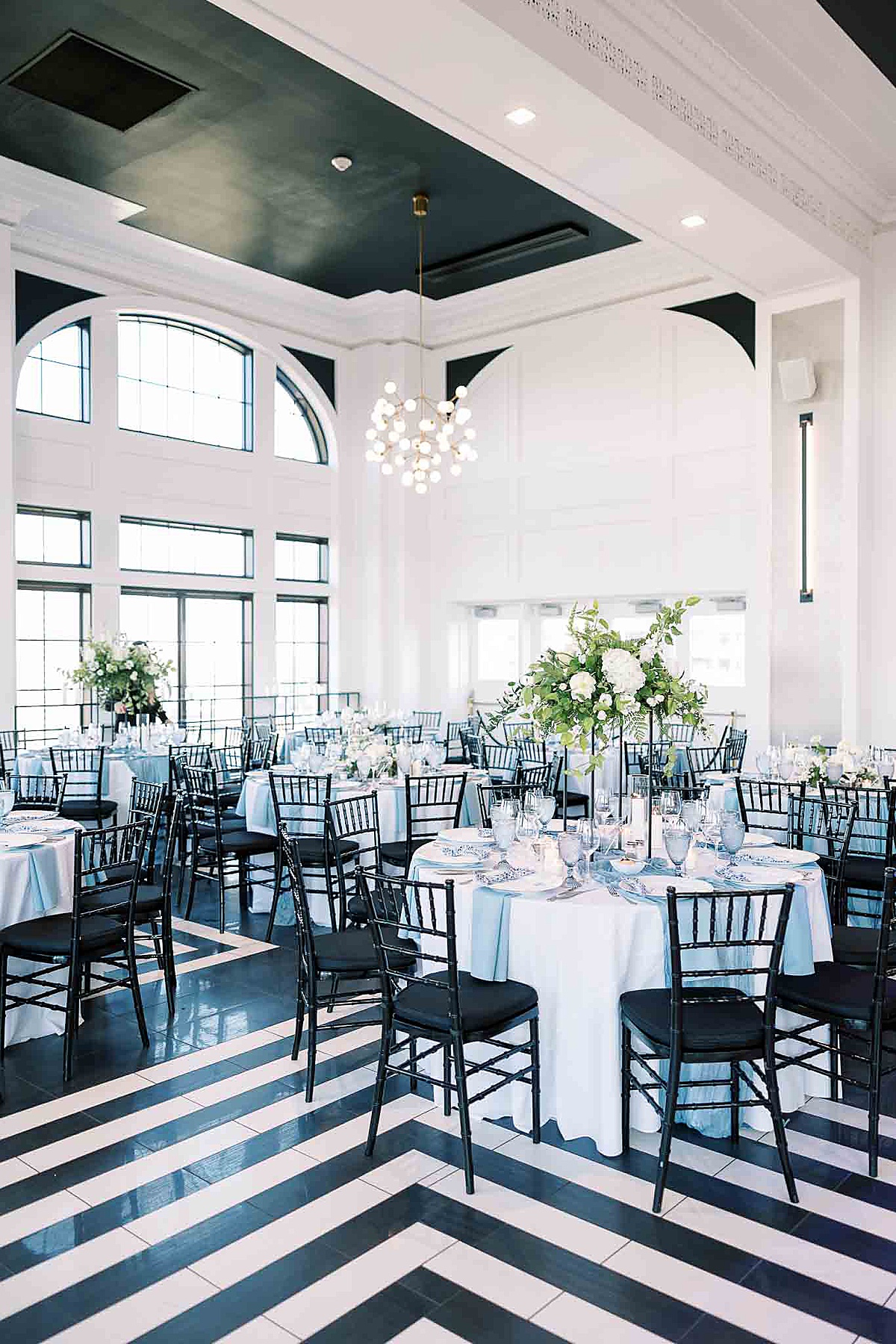 Black and white floor with blue tables