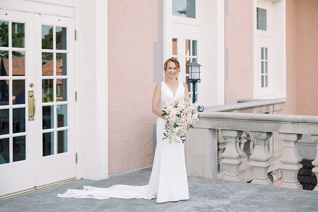 Classic portrait of a bride holding pink flowers