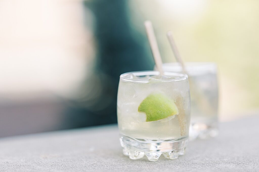 Drinks with limes sitting on concrete