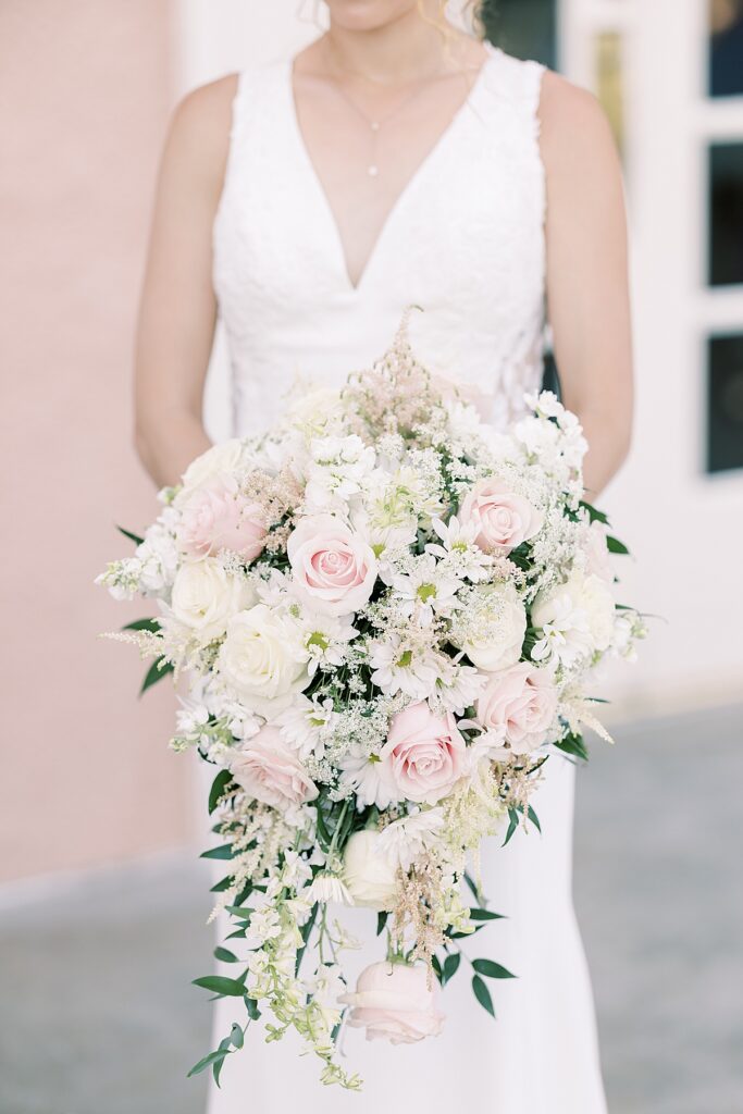 Bride holding large pink and white bouquet