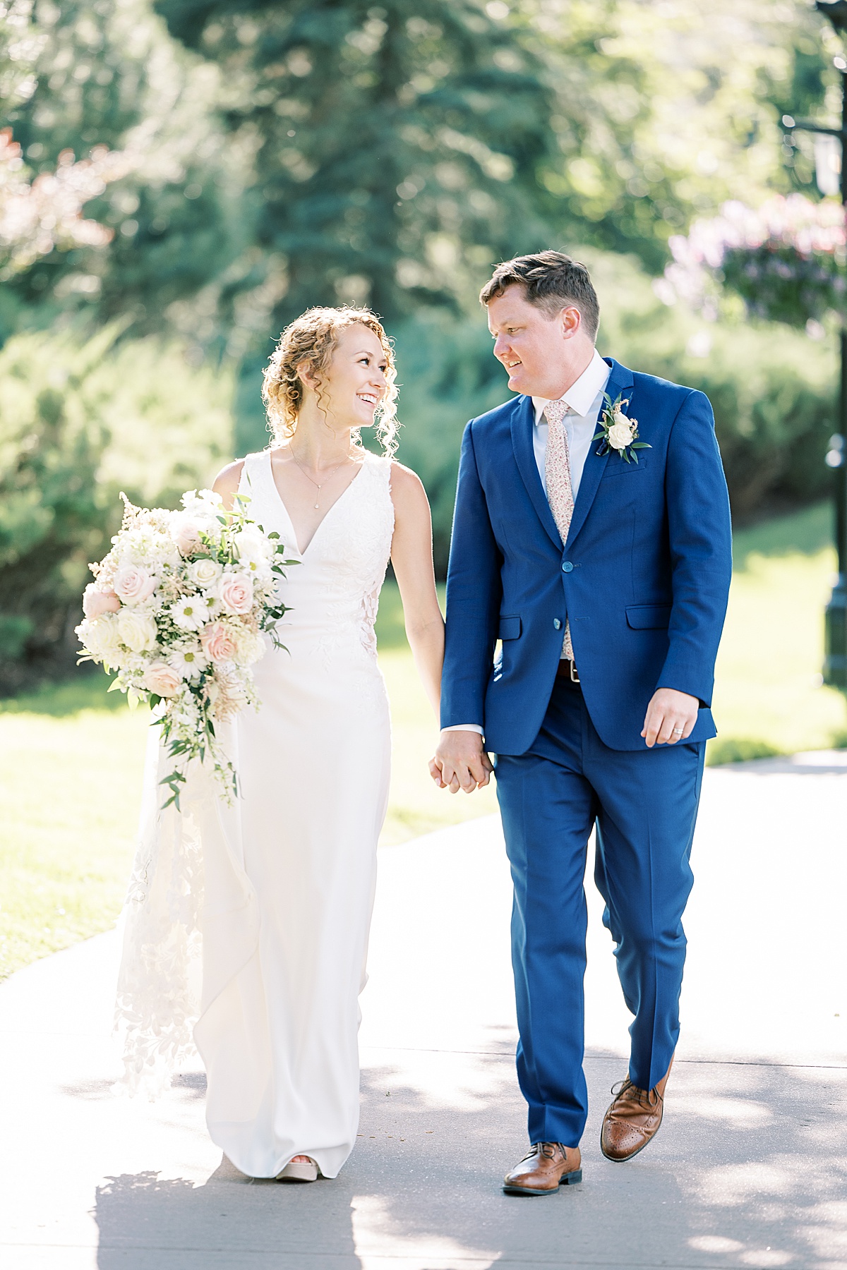 Couple smiling at each other walking on concrete path