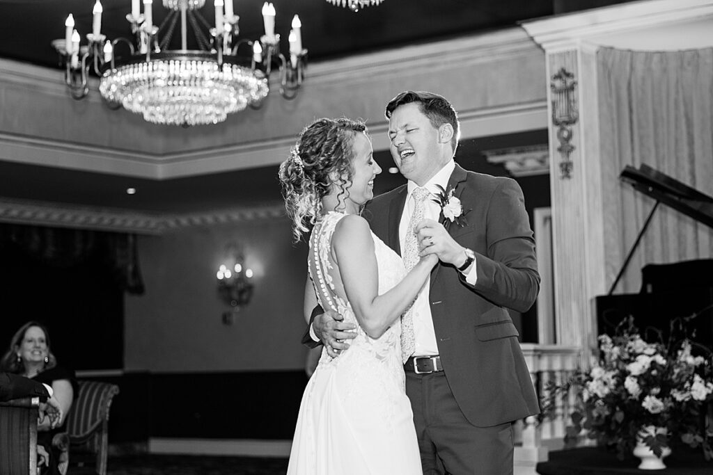 Black and white image of bride and groom dancing