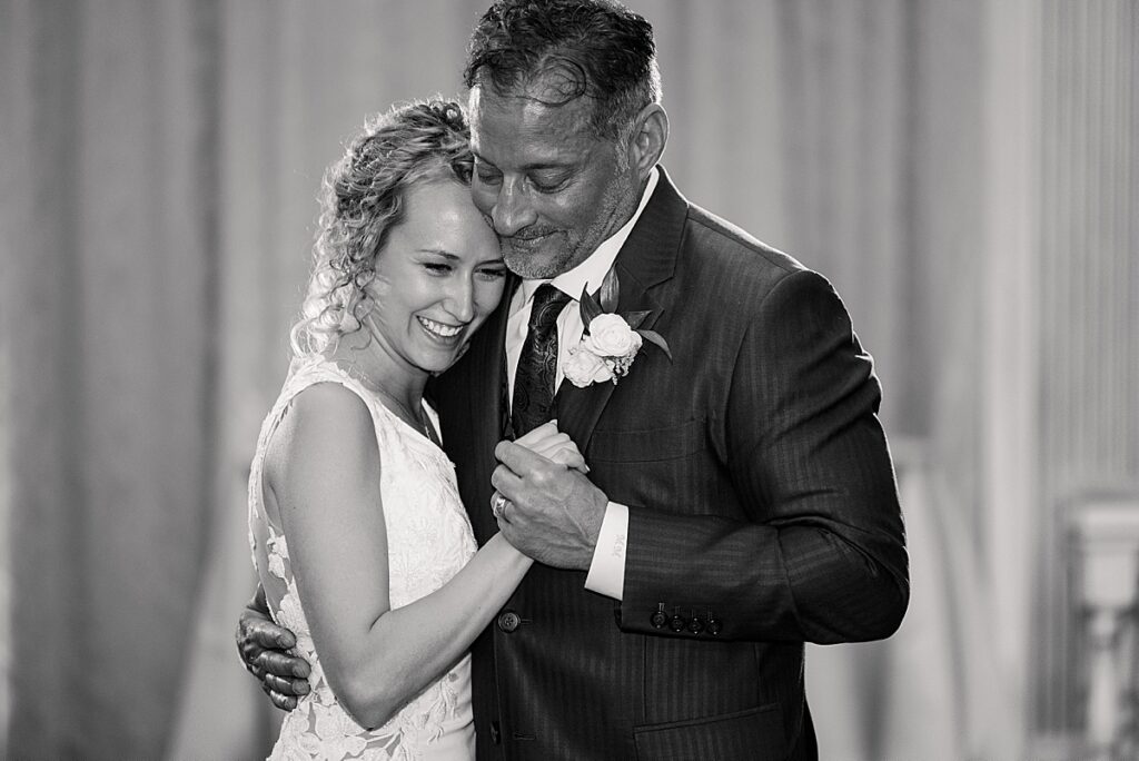 Black and white image of bride and father dancing