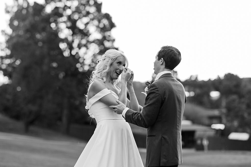 Bride wiping her tears on her wedding day