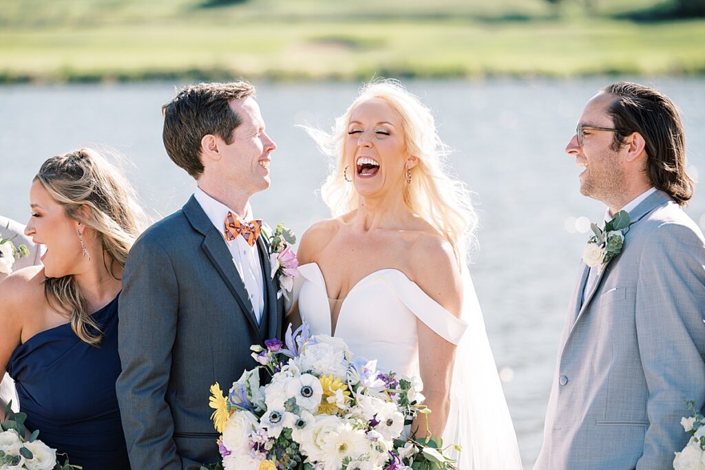 Woman laughing holding flowers on her wedding day