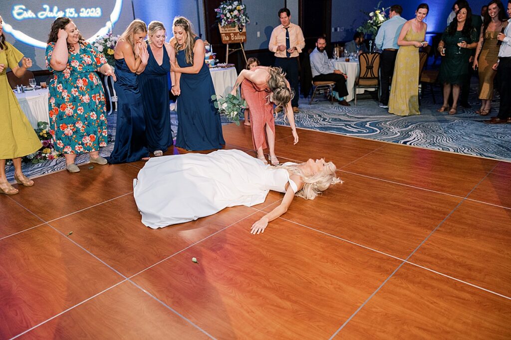 Bride laying on dance floor