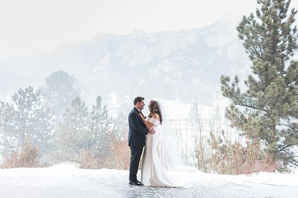 Bride and groom standing in front of mountains