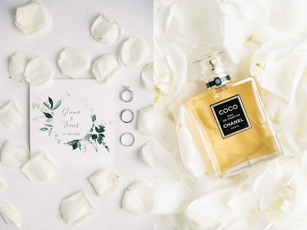 Wedding invitation and perfume surrounded by white rose petals