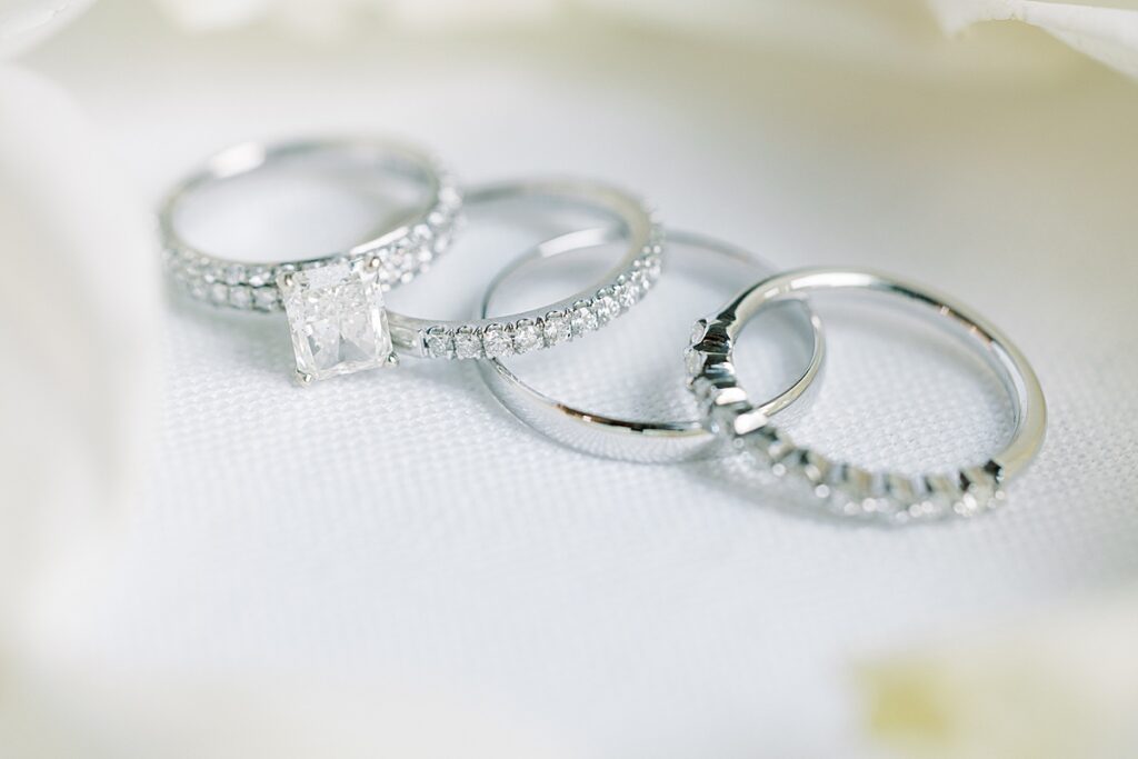 Wedding rings surrounded by ivory florals