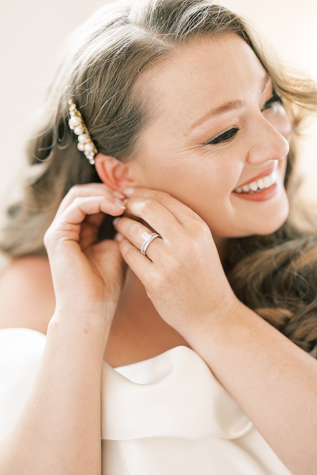 Bride putting on earring