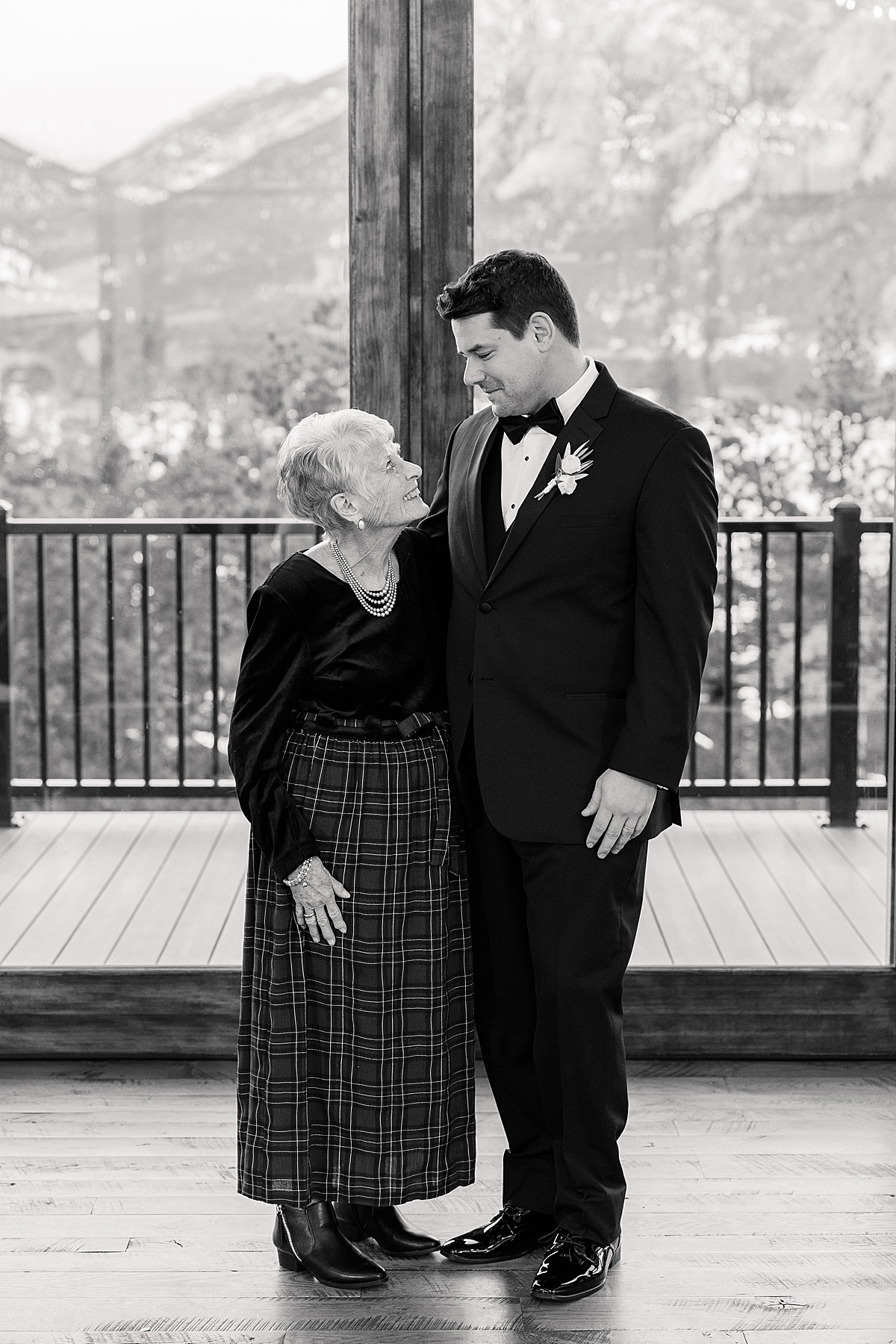 Groom smiling at his grandmother in portrait 