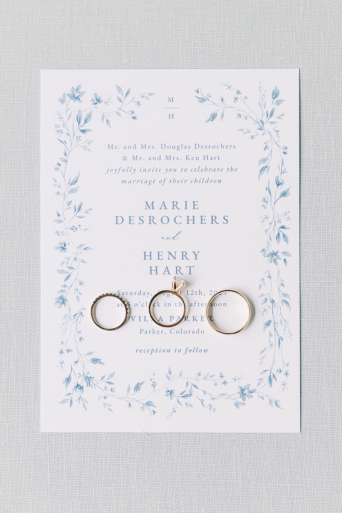 Wedding invitation with three rings laid across