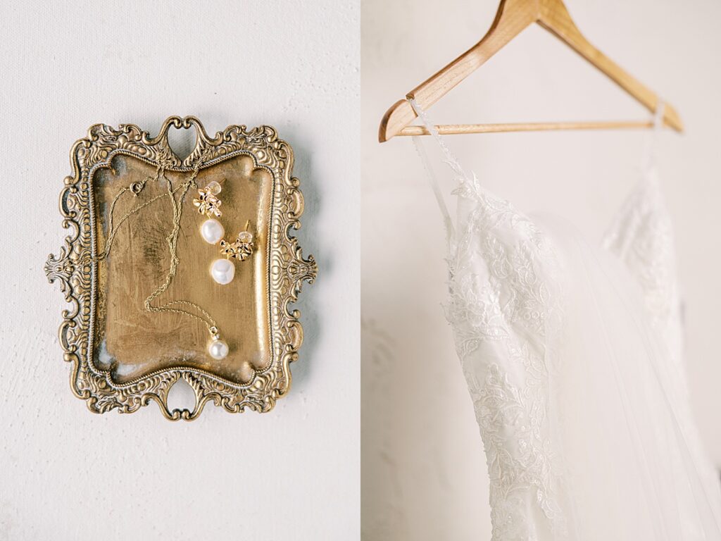 Wedding rings and wedding dress hanging on wooden hanger