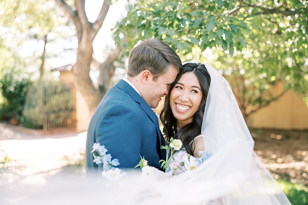 Bride looking over her shoulder with veil in front of face