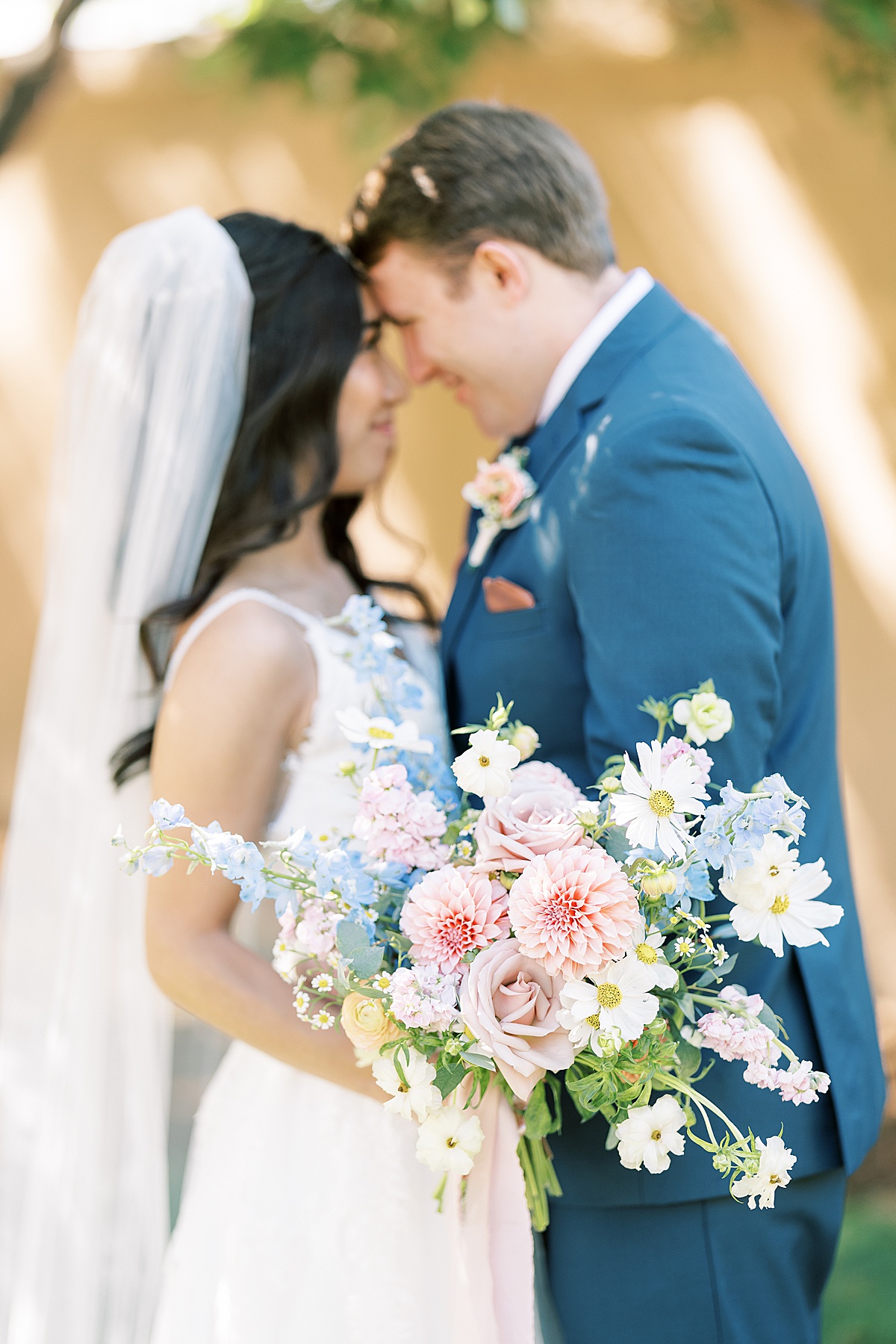 Bride and groom standing together holding flowers