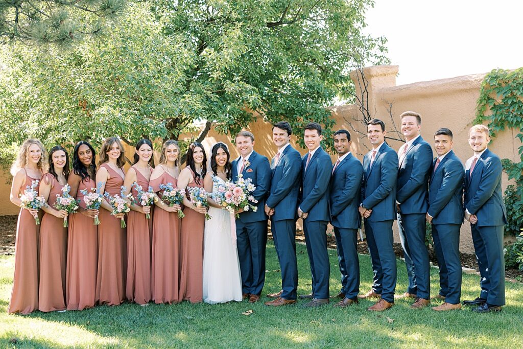 Wedding party in salmon dresses and blue suits