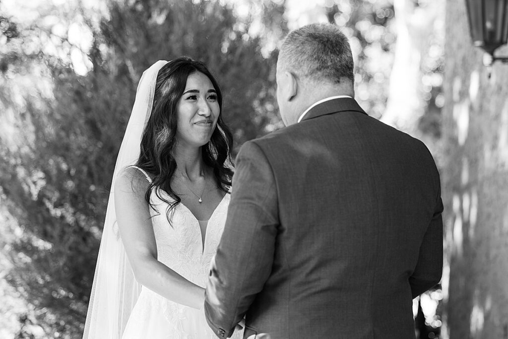 Black and white photo of bride staring up at man