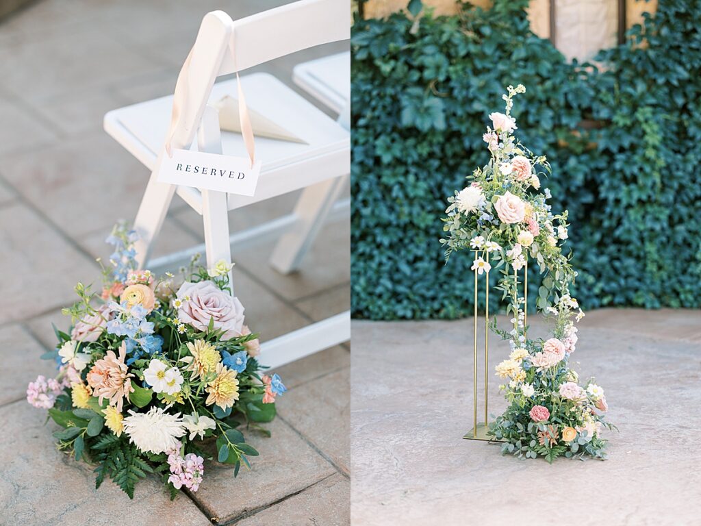 Pink, yellow and blue flowers next to a chair during wedding ceremony