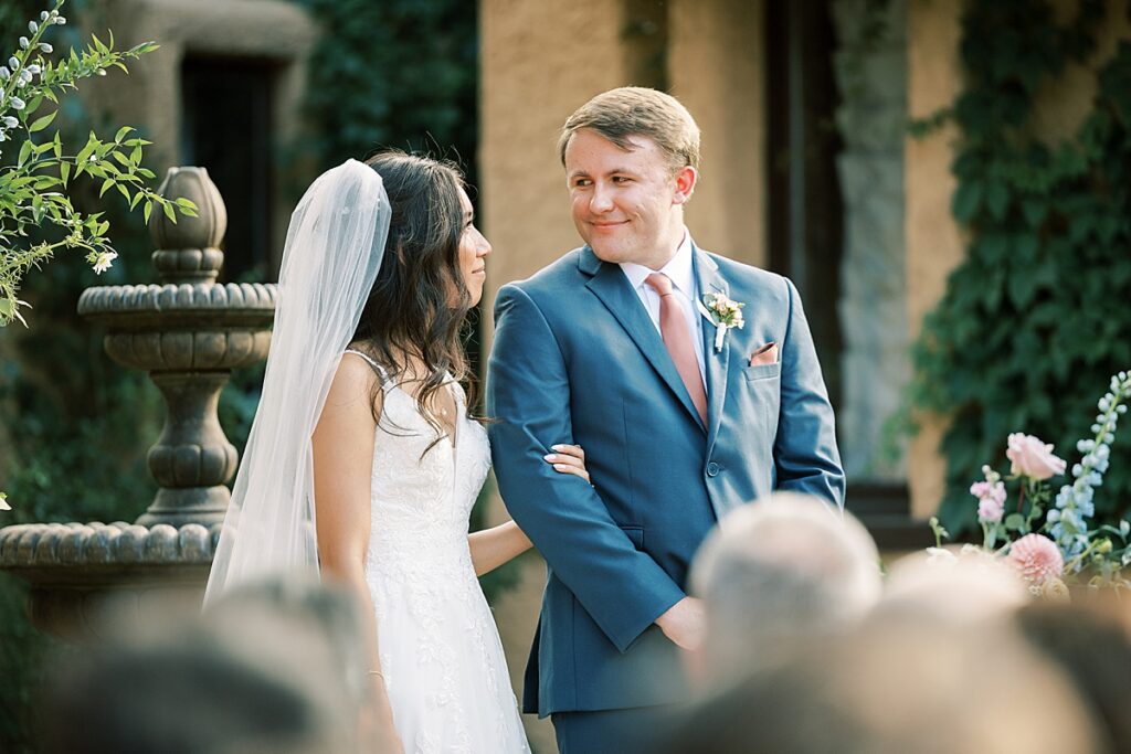 Bride and groom looking at each other during wedding ceremony