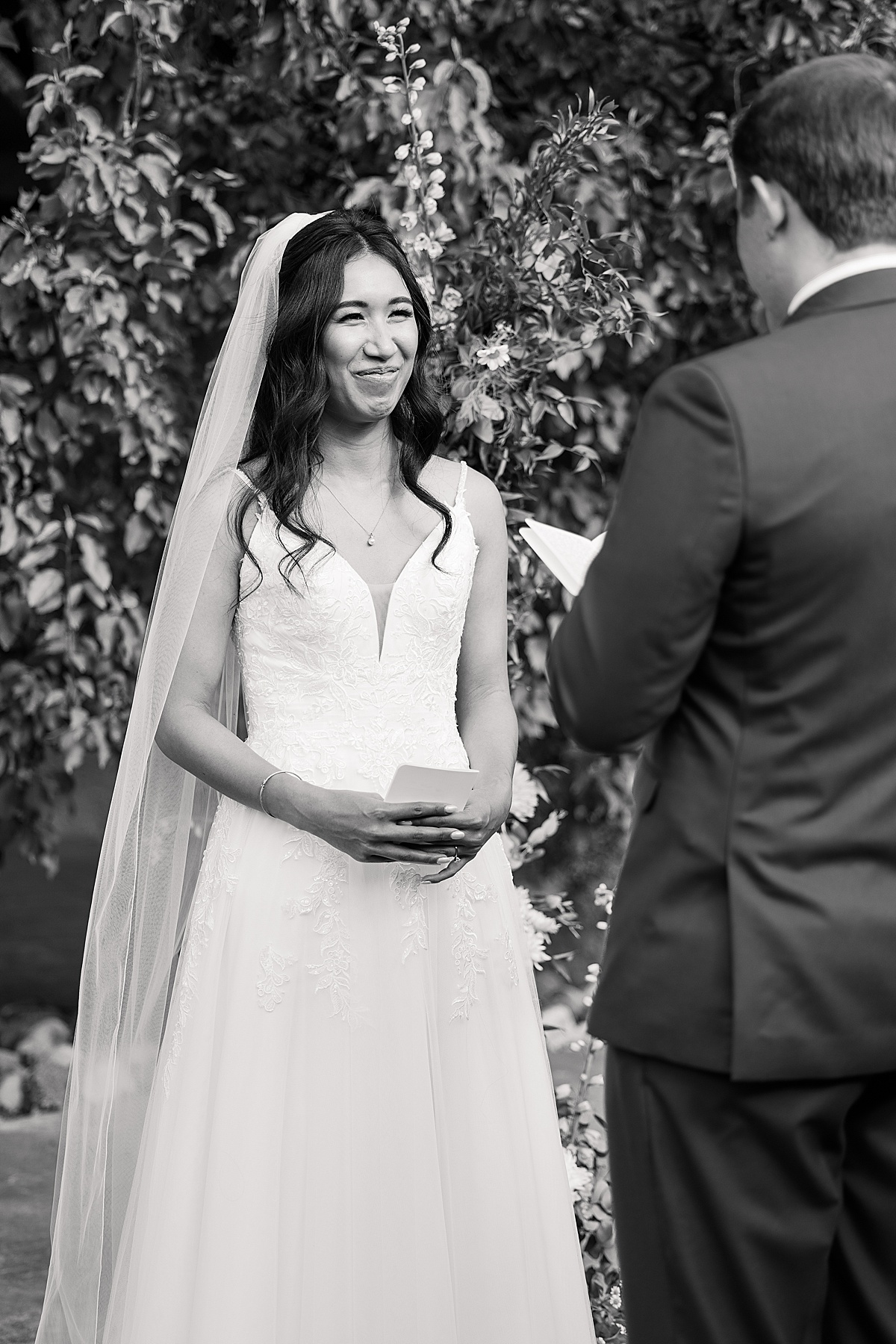 Black and white photo of bride during wedding ceremony