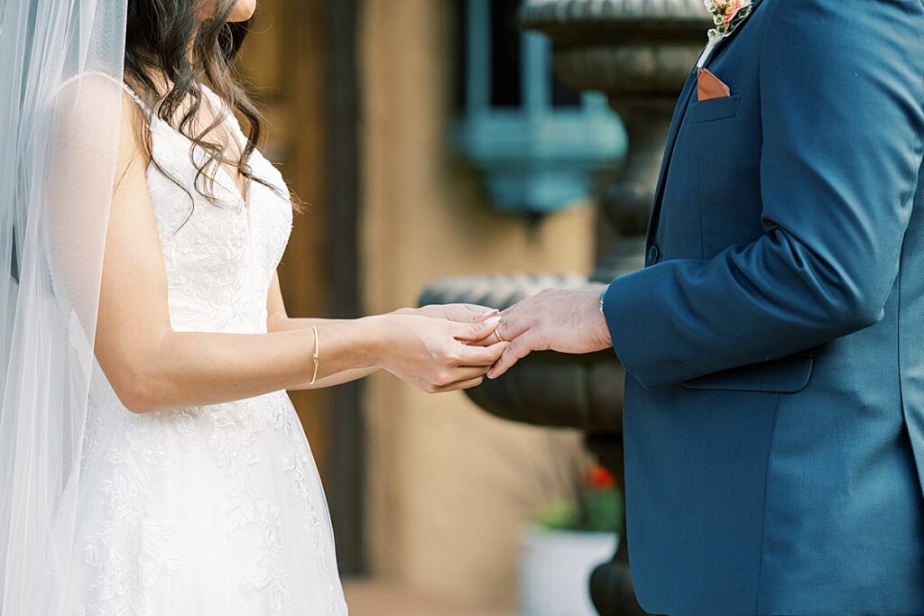 Couple exchanging rings at wedding ceremony