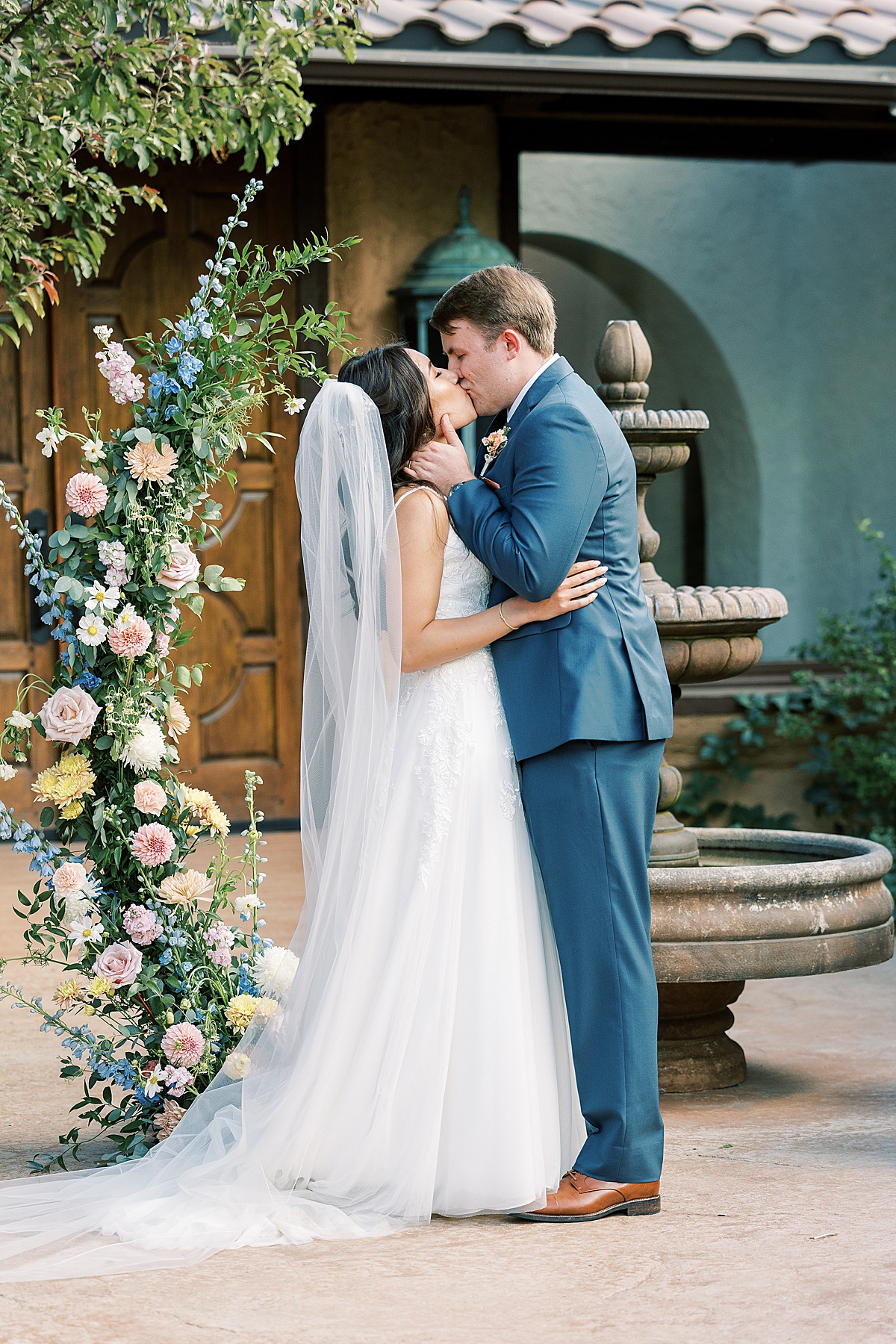 Bride and groom kiss at the altar after wedding ceremony