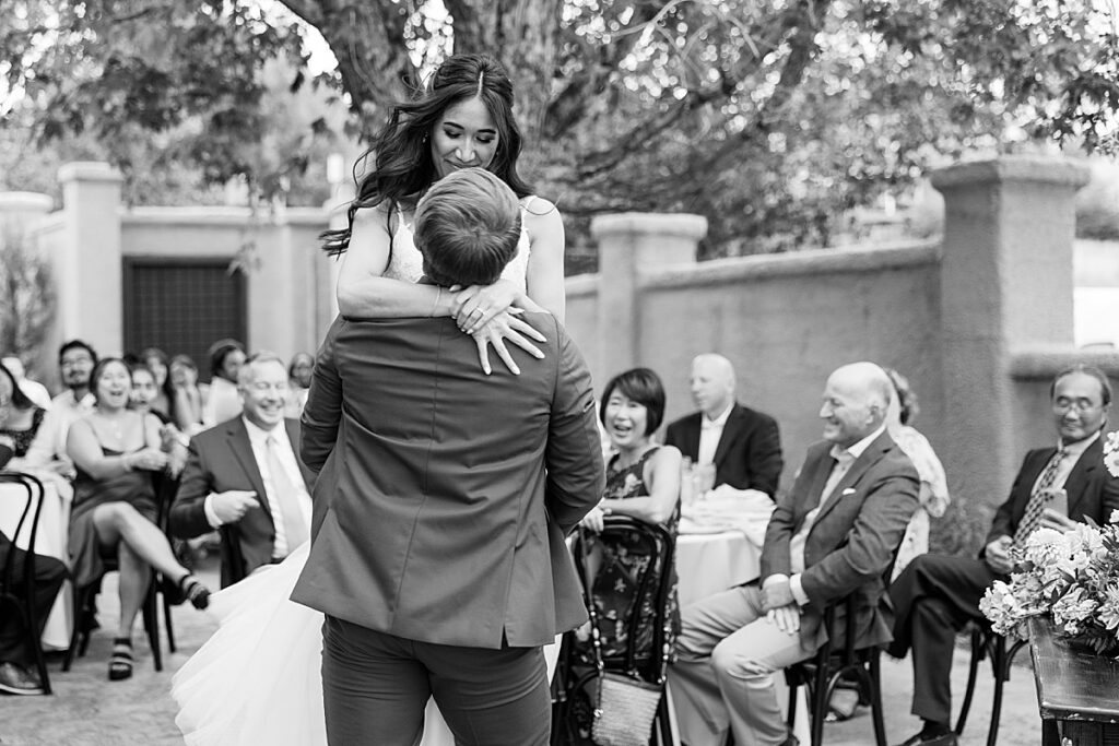 Black and white photo of bride spinning during first dance