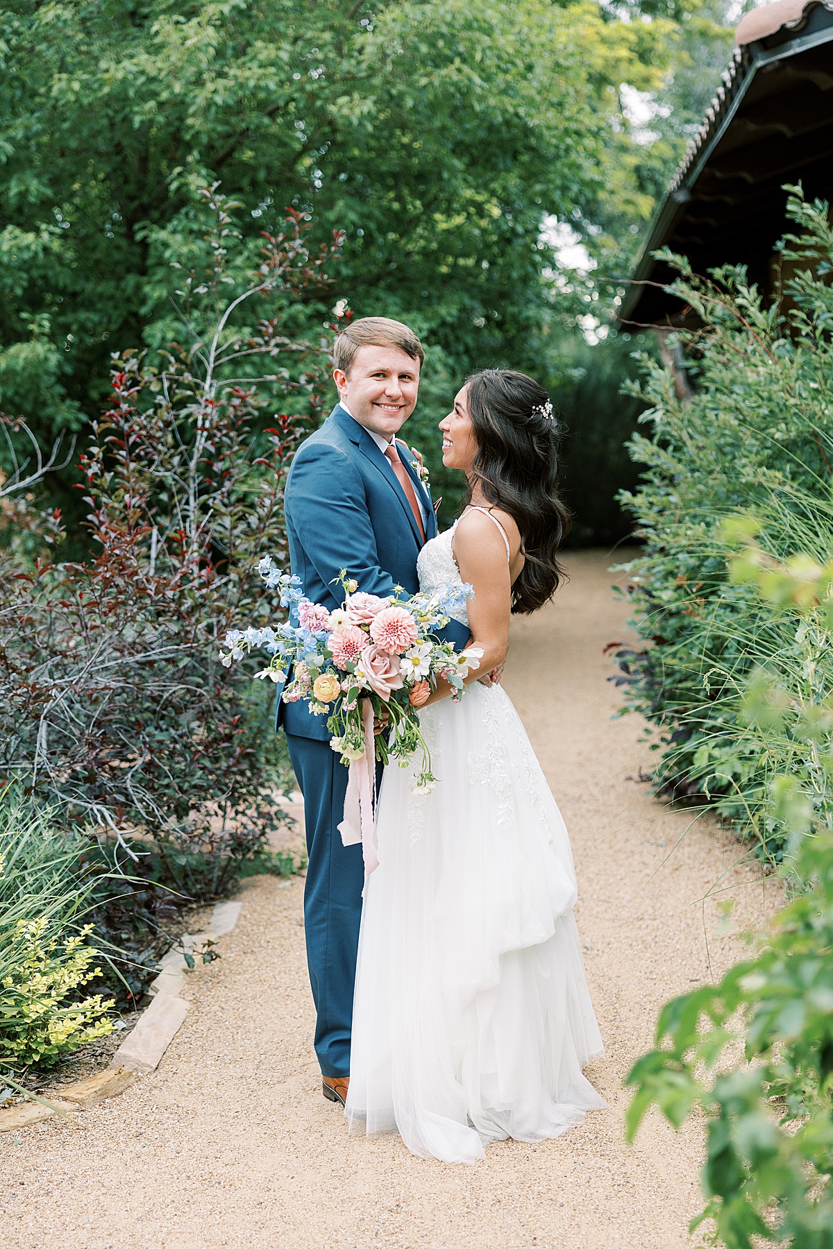 Groom smiling at camera while holding