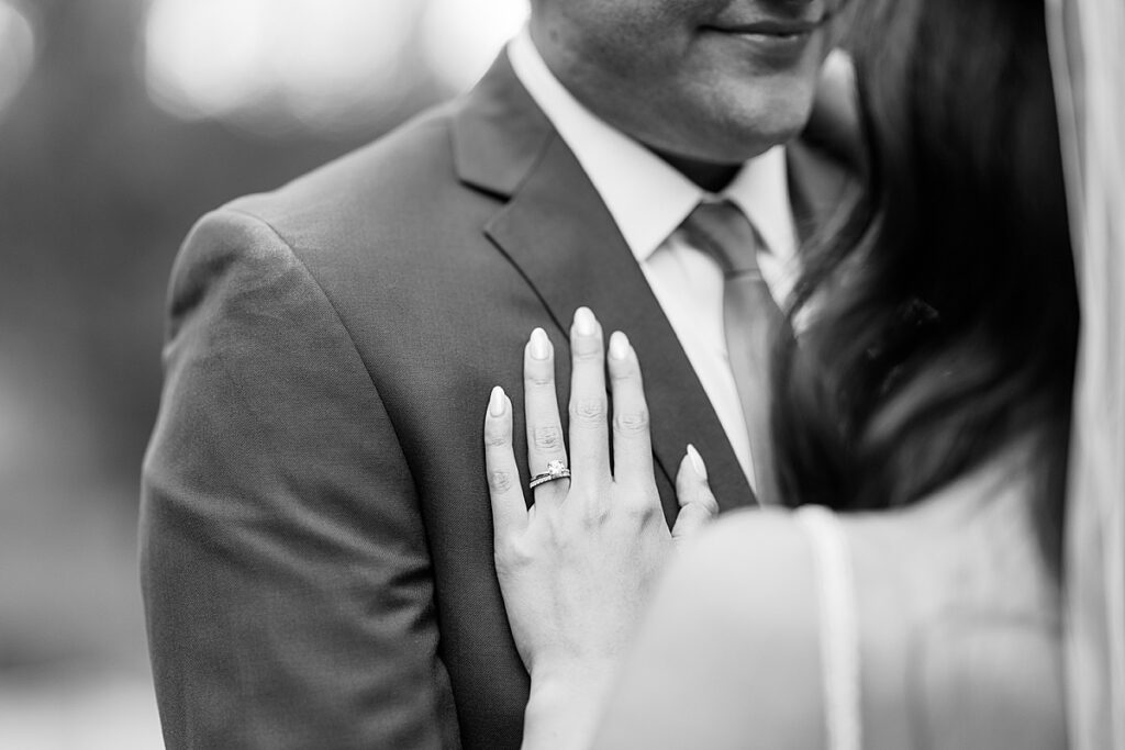 Black and white photo of wedding ring on man's chest