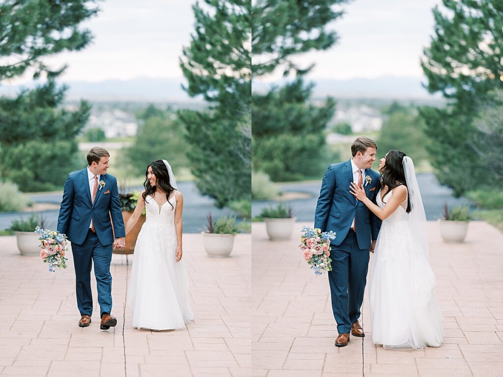 Couple in blue suit and wedding dress walks up paver walkway