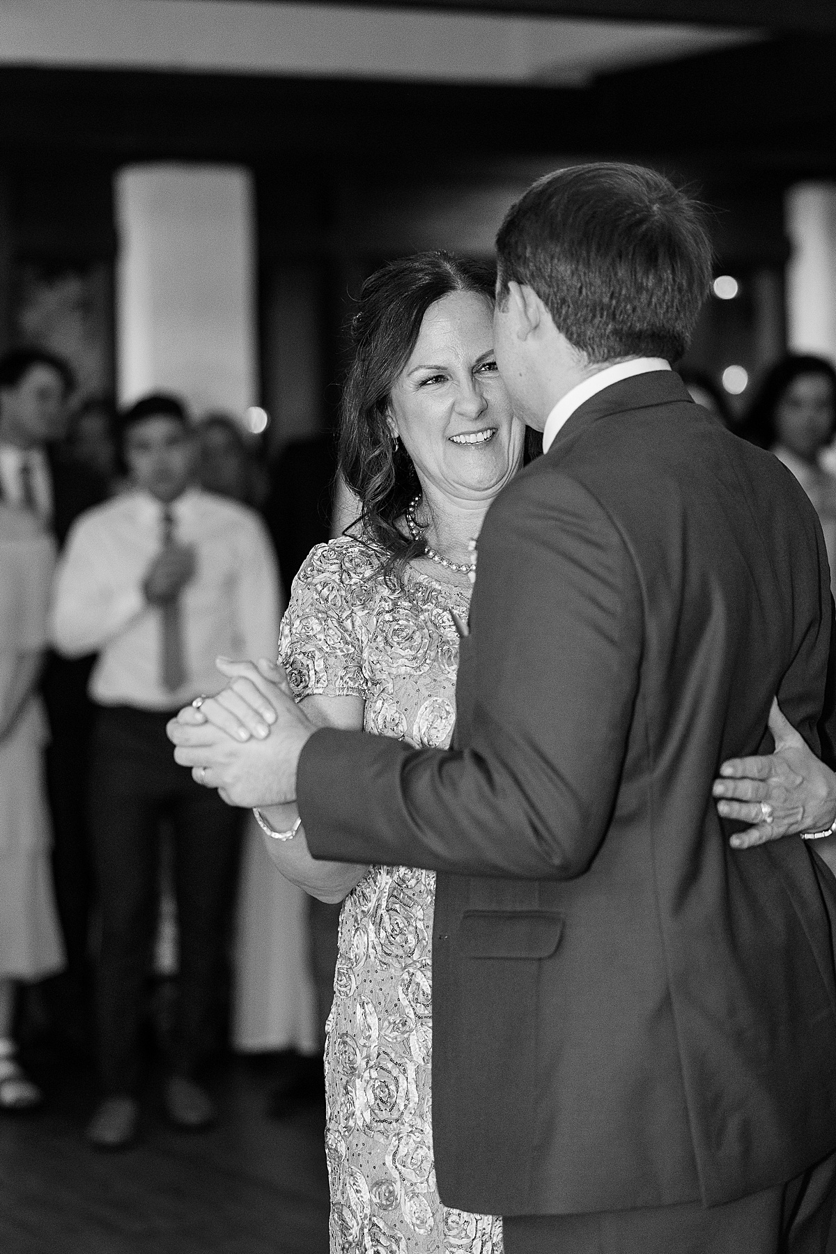 Black and white photo of mom and son dancing