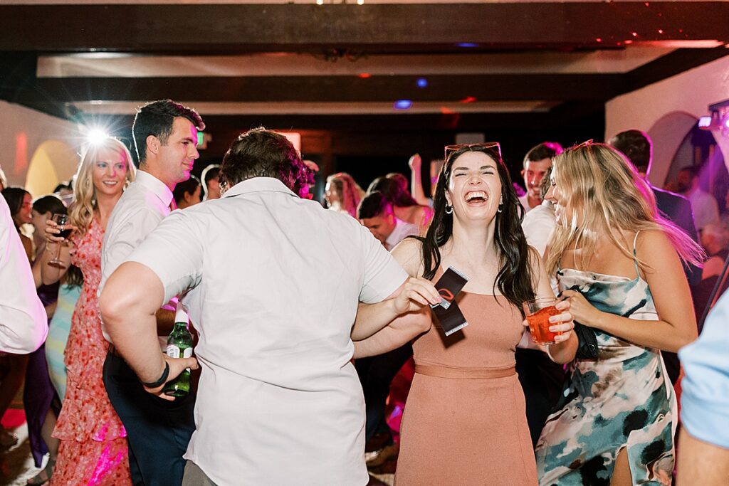 Wedding guest in pink dress dancing