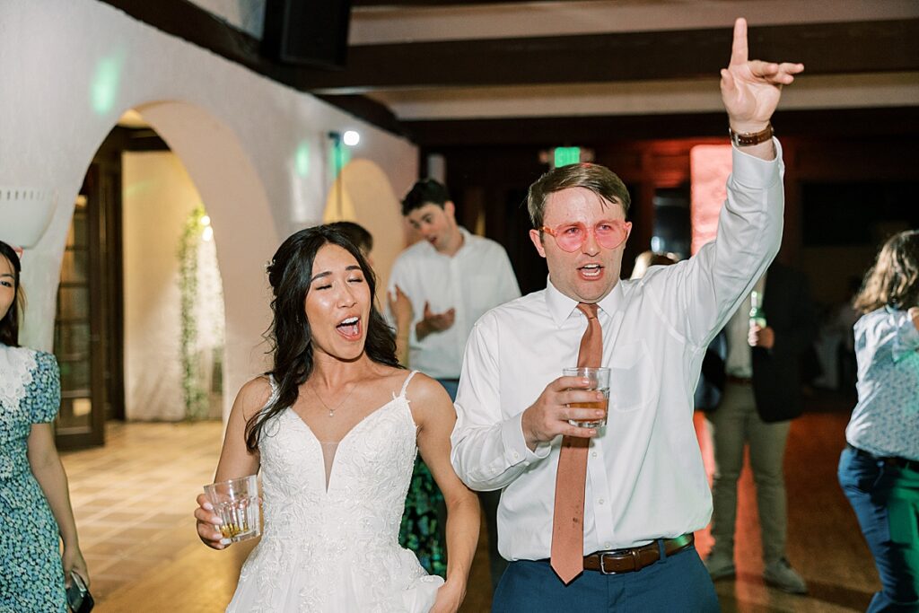 Groom dancing with his hands in the air