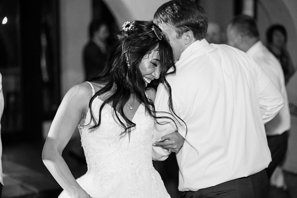 Black and white photo of bride and groom dancing