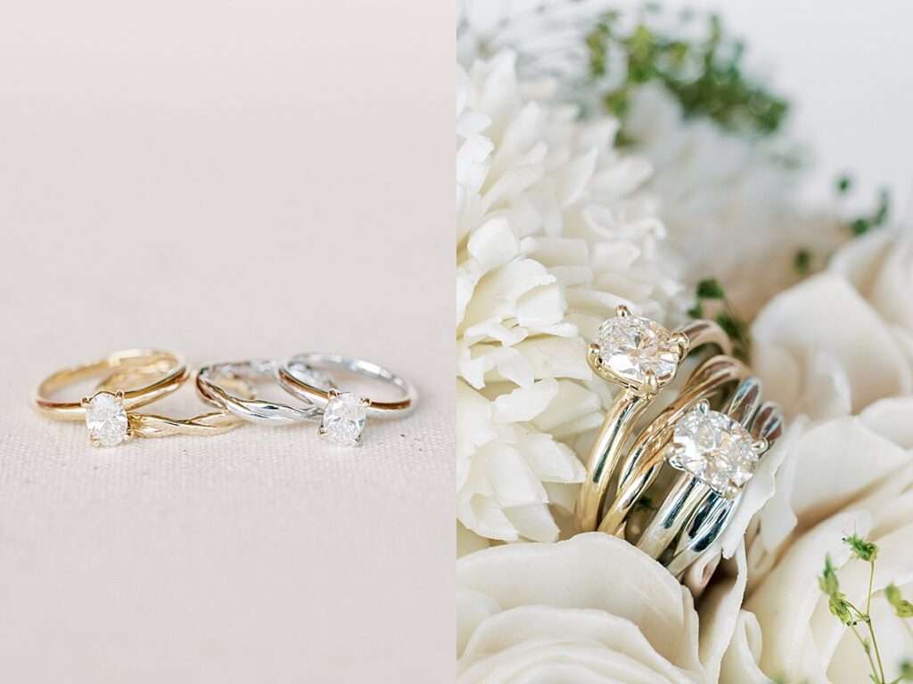 Two oval shaped engagement rings sitting inside wooden flowers