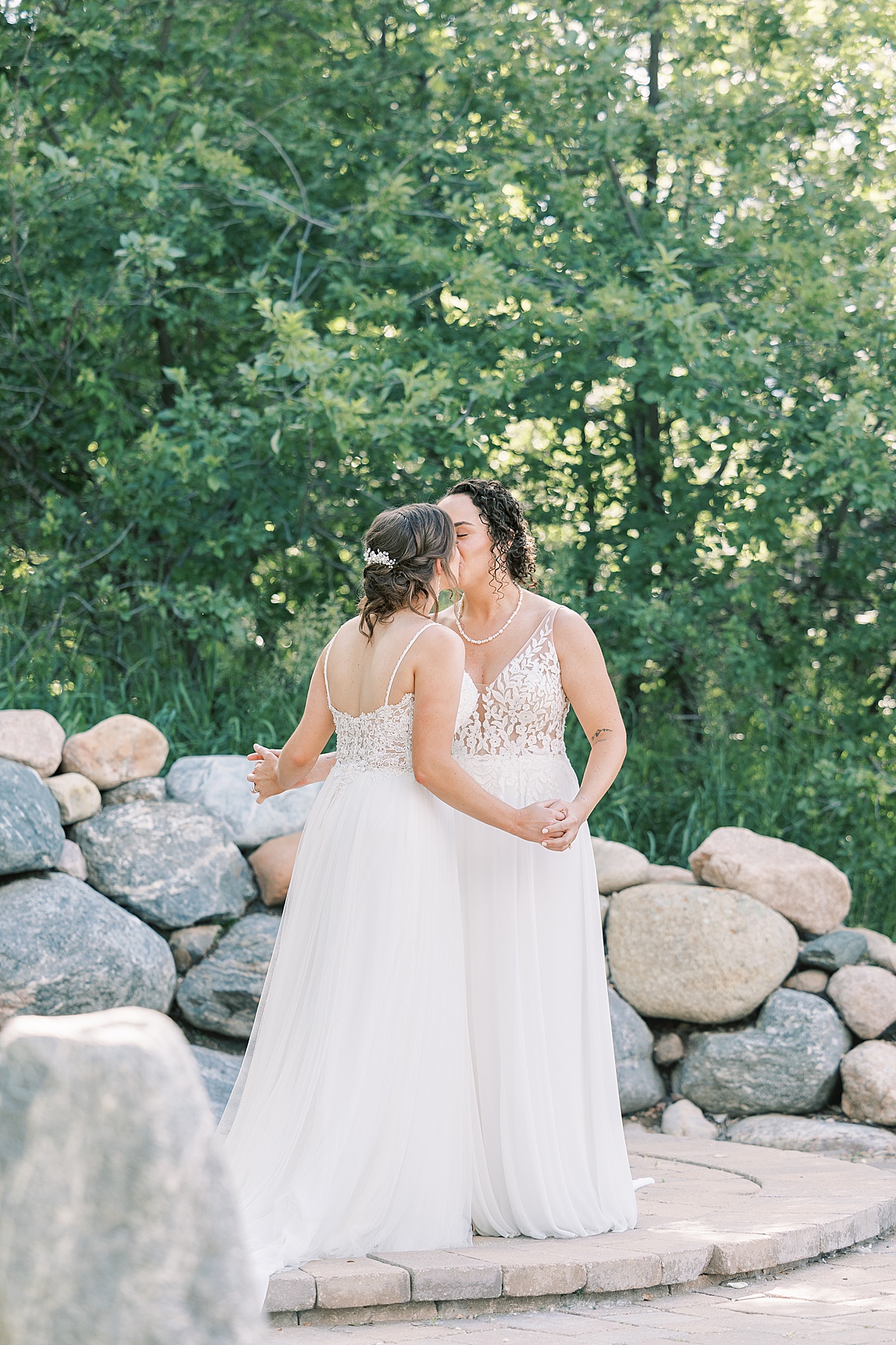 Two brides kissing at wedding altar after their wedding ceremony