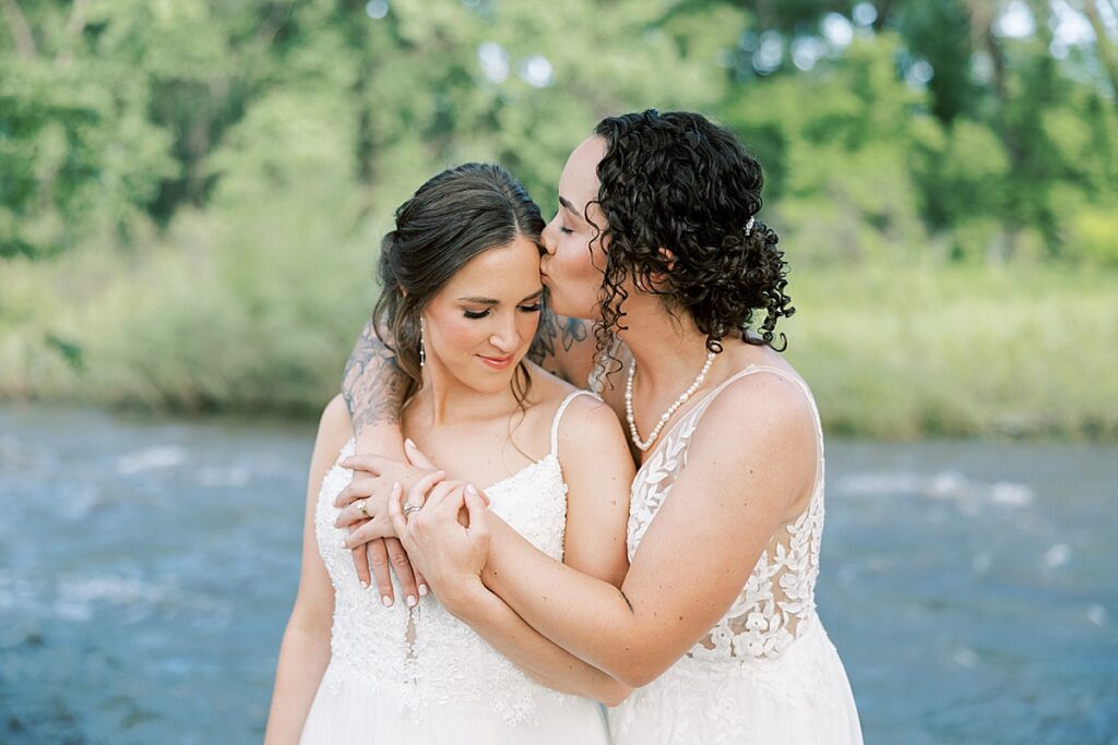 Woman with dark hair with her arms around woman with brown hair