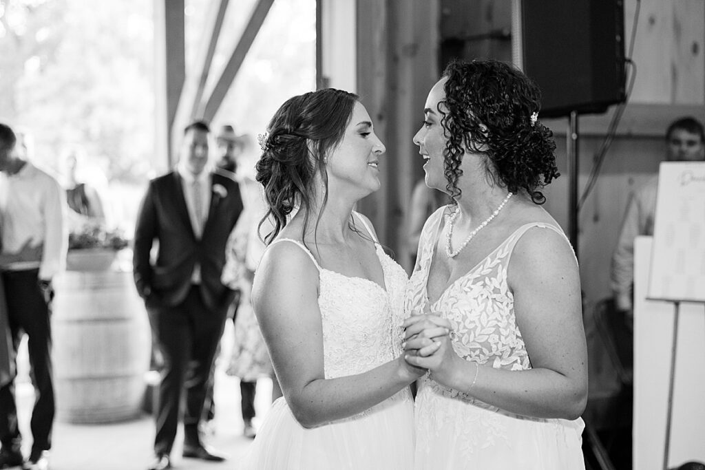 Two women sharing their first dance smiling