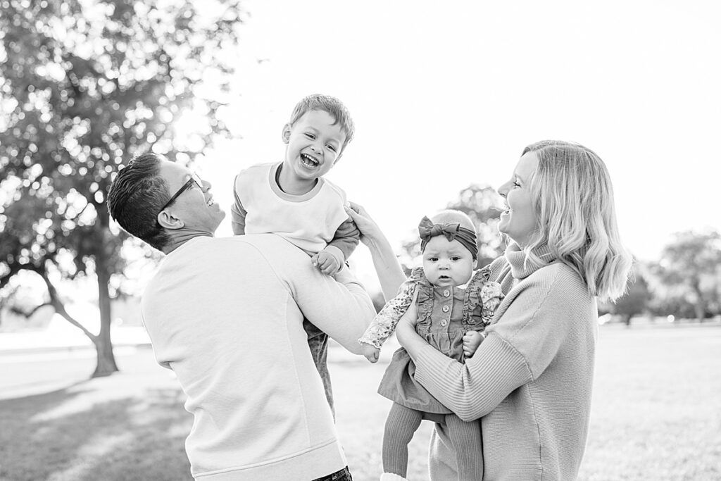 Black and white photo of a man and woman holding a young baby and young boy