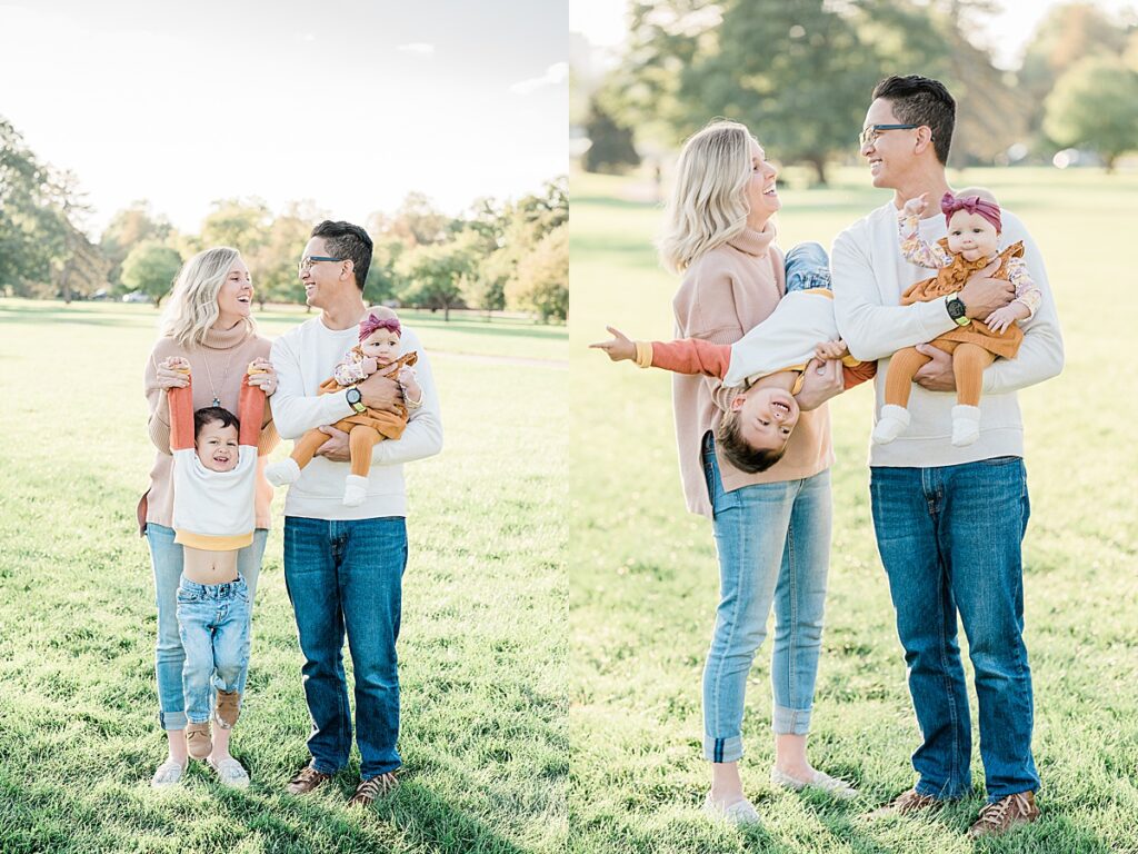 One man and one woman laughing at each other while holding baby and toddler