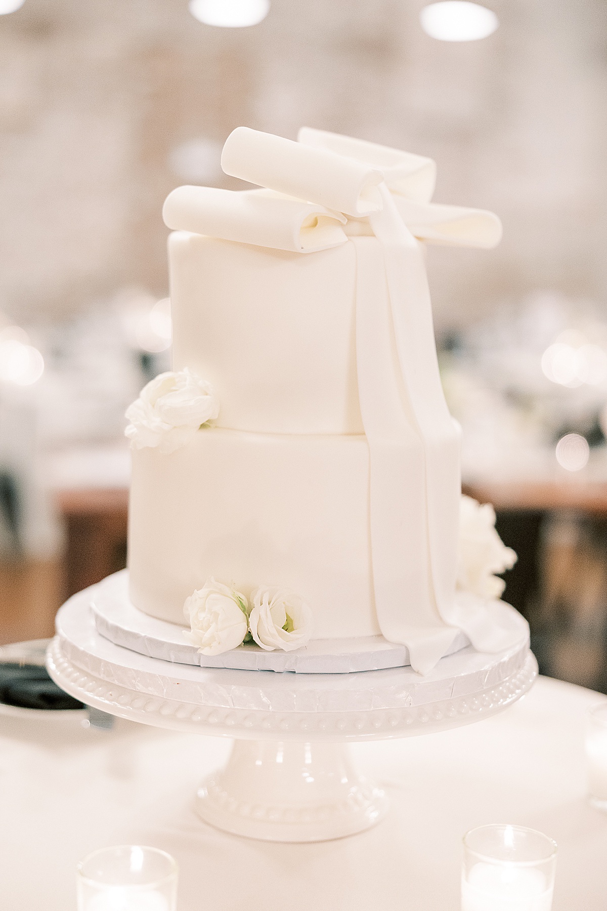 White wedding cake with bow on top