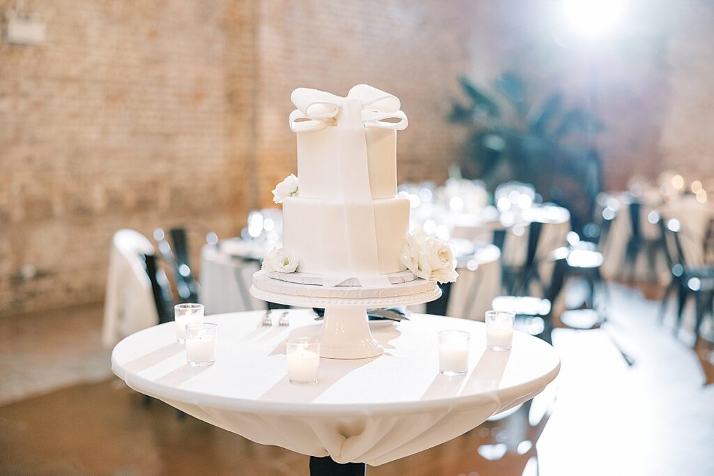 White wedding cake with bow on top