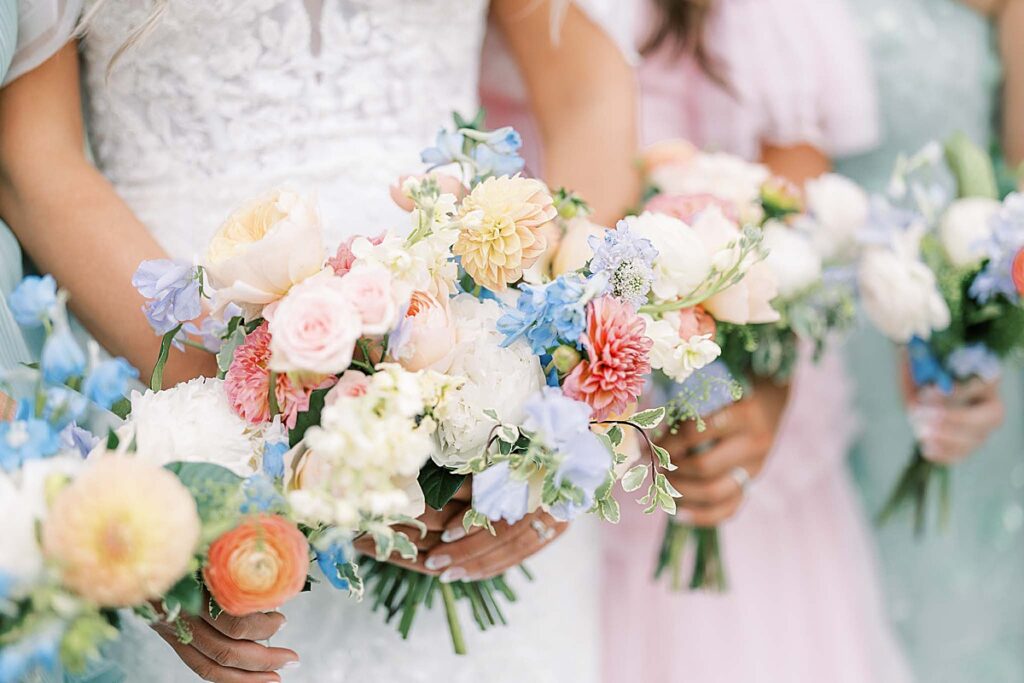 Close up photos of flowers in front of pink and green bridesmaid dress